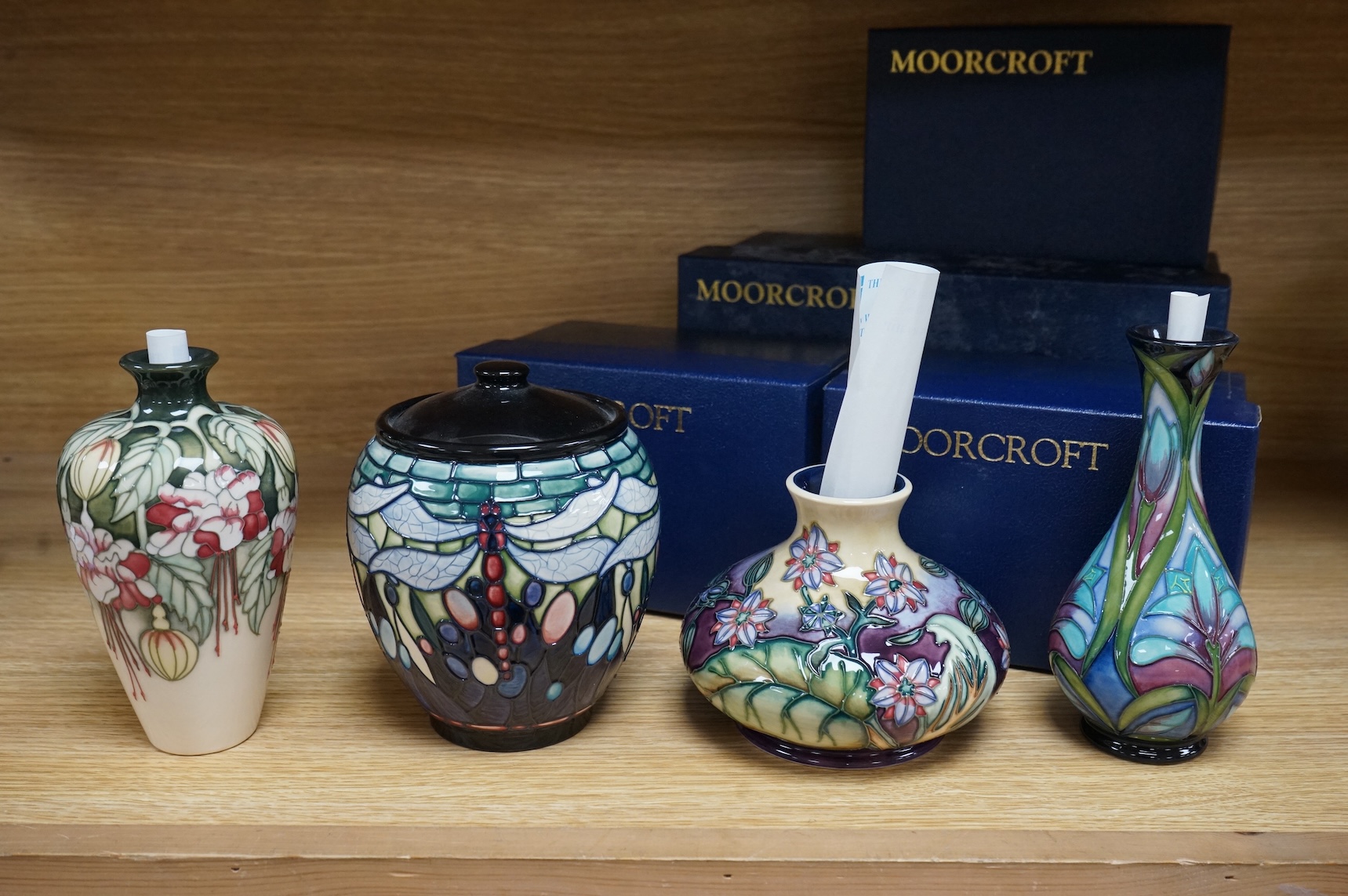Four Moorcroft vases: Favrile Jar, Kerry vase, Cleopatra vase and a Borage vase. All boxed, tallest 17cm